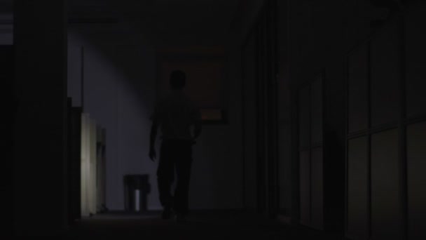 Security Guard makes a detour In Corridor Of The Building Using Flashlight — Stock Video