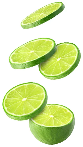 Isolerade flygande limefrukterna. Fallande skivad lime frukt isolerad på vit bakgrund med urklippsbana — Stockfoto