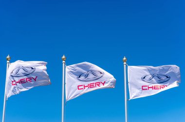 Vologda, RUSSIA - MAY 29, 2018: Official dealership flags of Chery against the blue sky background. Chery automobile clipart