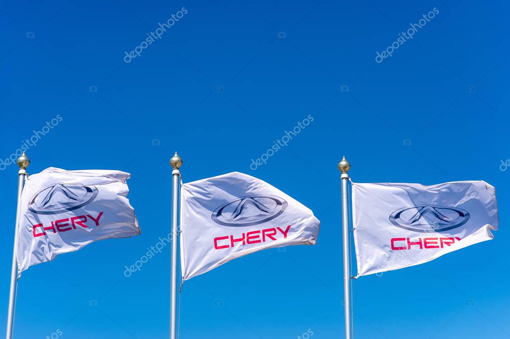 Vologda, RUSSIA - MAY 29, 2018: Official dealership flags of Chery against the blue sky background. Chery automobile