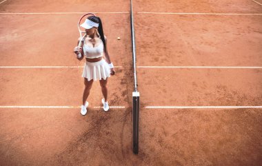 Kazanmak hazır! Üstten görünüm seksi kadın tenisçi uzakta kil tenis kortunda arıyorum. Tenis Eğitim Kulübü Sportif kız tam uzunlukta vurdu. Aktif egzersiz.