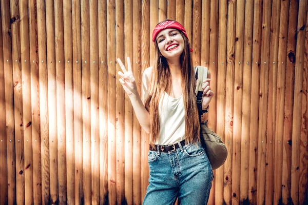 Happy Young Woman Standing Isolated Wooden Background Showing Peace Gesture — Stock Photo, Image