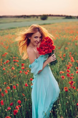 mutlu kadın çiçekli haşhaş alanda yürüyüş