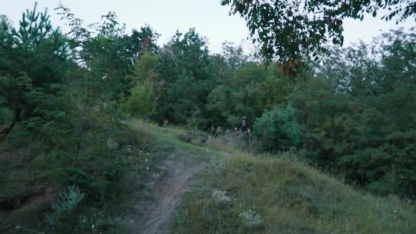 Extreme bicyclist rides on forest path, slow motion — Stock Video