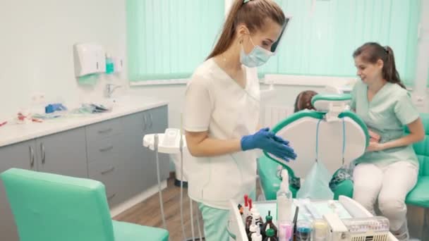 Asistente de dentista prepara herramientas antes del tratamiento del paciente — Vídeos de Stock