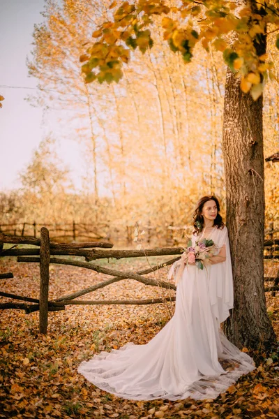 Bruid in boho stijl staan op de achtergrond van de herfst natuur — Stockfoto
