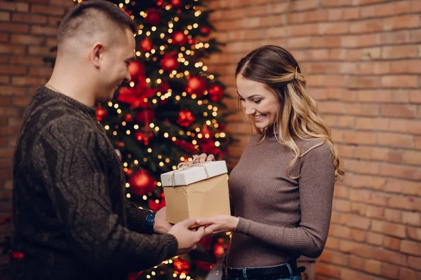 Happy wife gets Christmas present from her husband — Stock Photo, Image