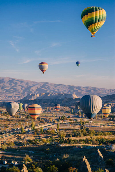 lots colorful balloons in sky above mountains
