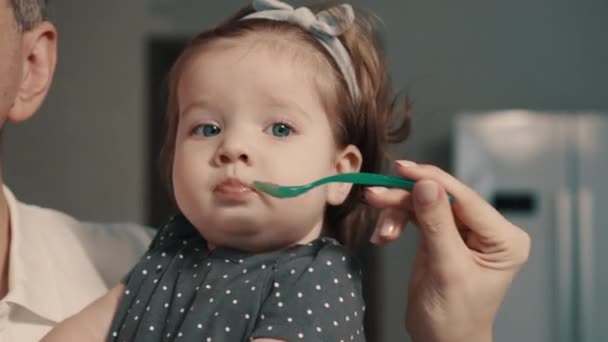 Νέοι γονείς ταΐσει το μωρό κόρη στο σπίτι — Αρχείο Βίντεο