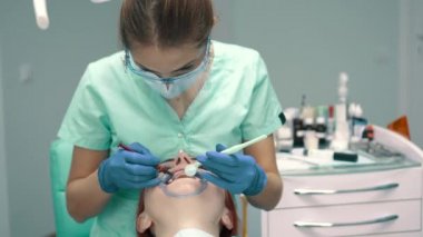 Genç kadın dişçi klinikte çalışırken