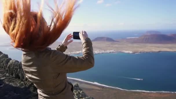 Happy woman tourist shoots video of beautiful view of islands using smartphone — Stock Video