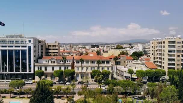 Aerial of Limassol, camera rises up above embankment overlooking buildings of city — Stock Video