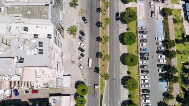 Légifelvételek az üdülőváros forgalmas utcájától parkolókkal és elhaladó gépkocsikkal — Stock videók