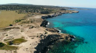 Güneşli bir günde Cape Cavo Greco yakınlarında hava manzaralı mavi göl
