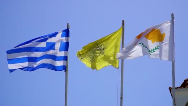 Fluttant dans les drapeaux de vent de Chypre et de la Grèce contre le ciel bleu, au ralenti — Video