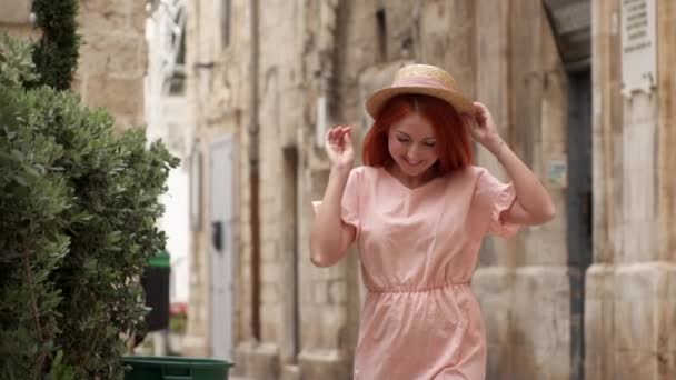 Happy young woman tourist walking through streets of old European city, slow motion — Stock Video