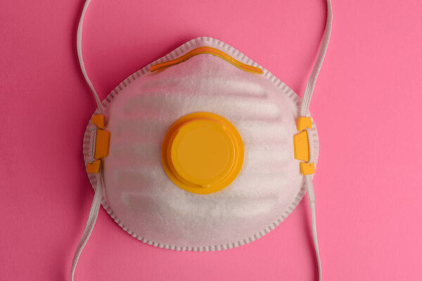 Protective mask on a pink background.