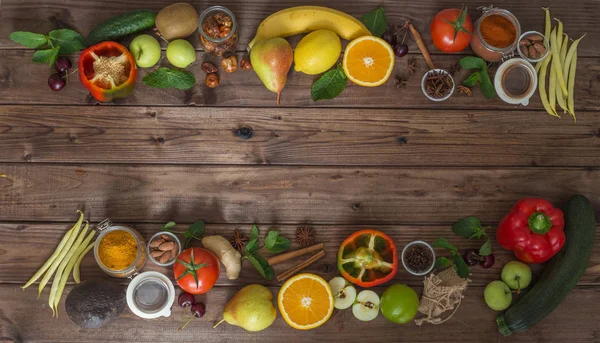 Healthy food, clean food selection:  fruits, vegetables, seeds, spices on brown boards with free space in the middle