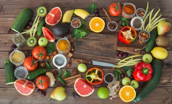 Healthy food, clean food selection:  fruits, vegetables, seeds, spices on brown boards with free space in the middle