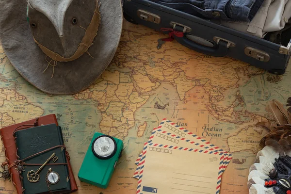 Old map, vintage travel equipment and souvenirs from the travel