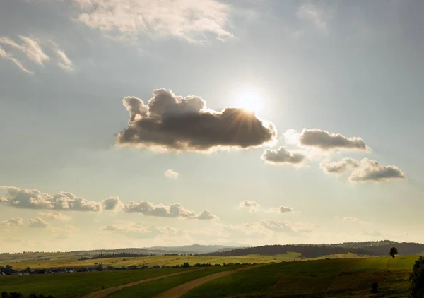 Hot day, the sun shining fiercely from behind the clouds