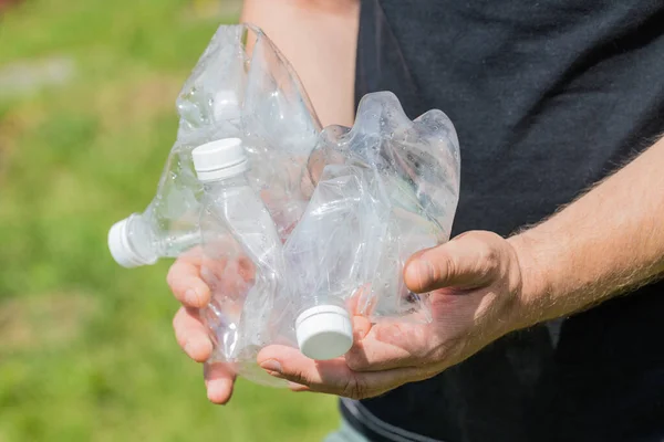 Man holding crushed plastic bottles in his hands, Concept, Eco friendly lifestyle, Zero Waste