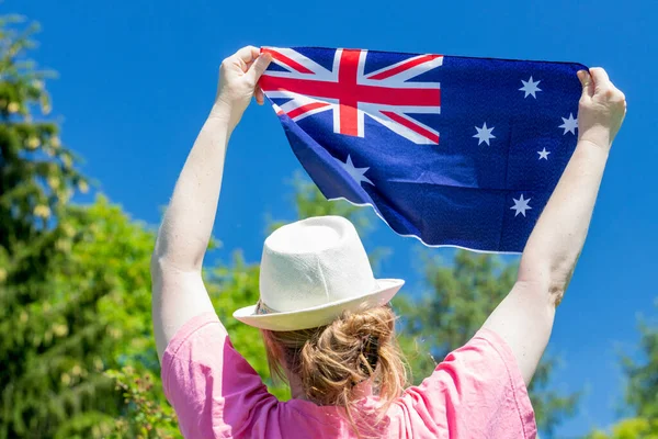 Girl holding the Australian flag during the Australia Day