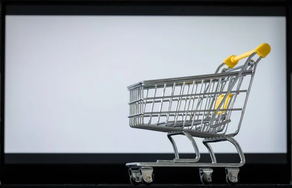 笔记本电脑键盘上的购物车 白色显示屏 带有文字空间 网上购物和网上商店的概念 — 图库照片