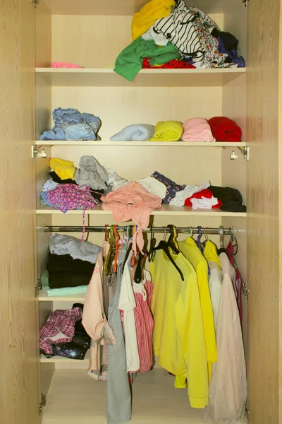 Colorful Clothes In The Closet. Cleaning Concept. Scattered Clothes In The Closet. Clothes In Dressing Room.
