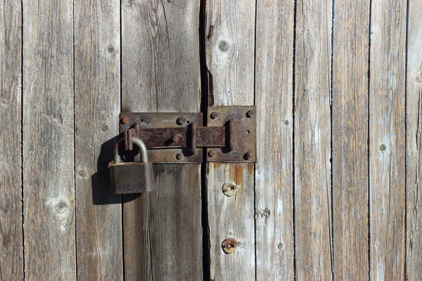 Old Wooden Fence. Close Up Shot Of Wooden Wall. Iron Lock On Wooden Door.