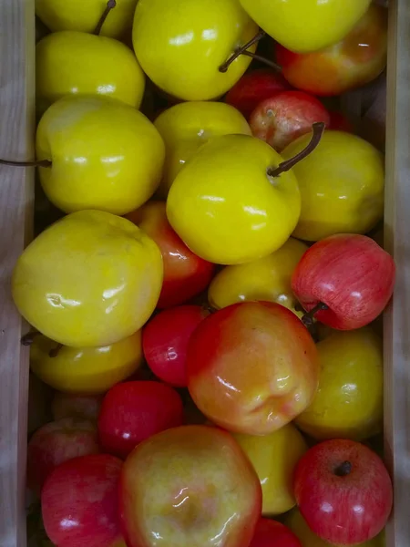 Plastic Apples In The Box. Abstract Colorful Background.