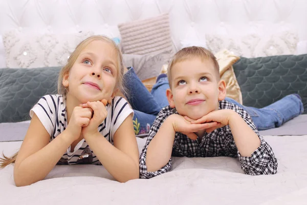 People, Happiness, Friendly Family, Children, Family Value Concept. Brother And Sister Playing. Boy And Girl Lying On A Bed. Elder Sister And Her Younger Brother Dreaming. — Stock Image People Happiness Friendly Family Children Family Value Concept Brother Sister Stock Photo