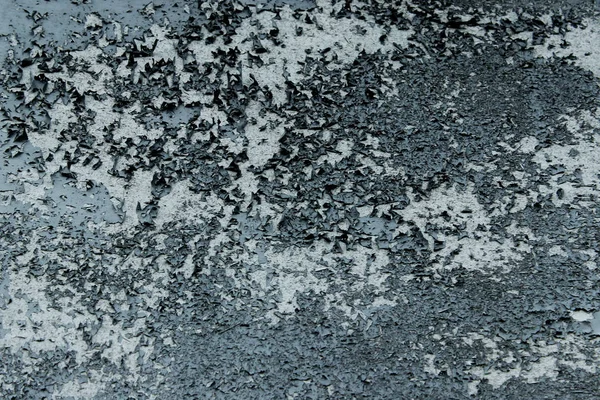 Dark gray paint on the wall. Abstract gray background. Old wall texture background. Painted textures.