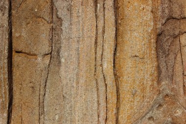 Taş duvar dokusunun bulanık görüntüsü. Soyut doku arka planı, kahverengi renkler.