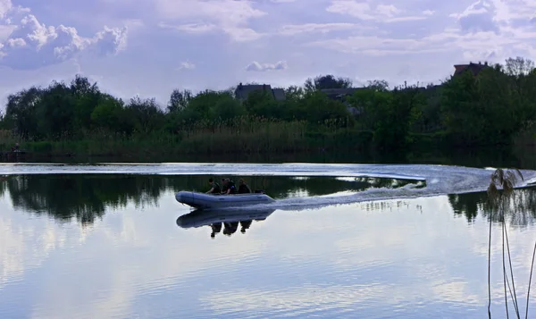 Fishing men in boat at river