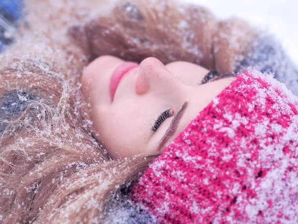 Girl laying at the snow portrait Stock Photo