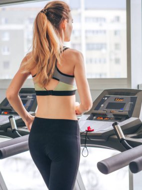 Genç kız spor salonunda egzersiz yapıyor.