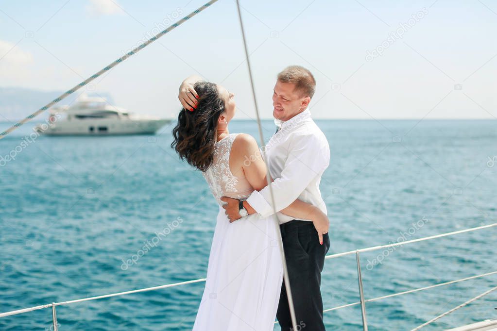 A Just married couple on yacht. Happy bride and groom on their wedding day