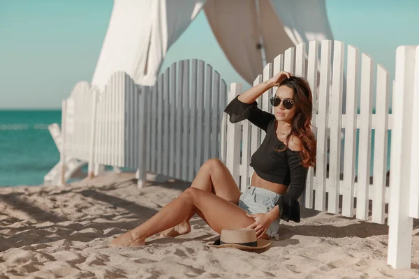 Una chica en bikini parada en la playa. Vacaciones de verano y concepto de vacaciones — Foto de Stock