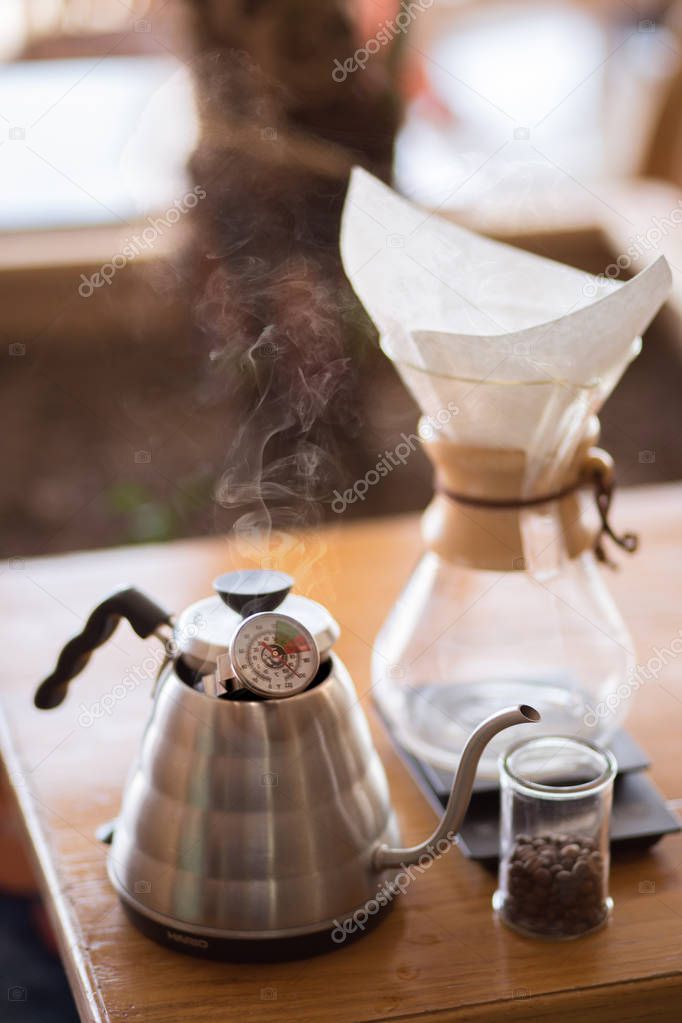 Close up of coffee brewing gadgets on wooden bar counter