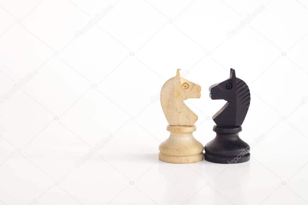 White horse and black horse, traditionally confronted in chess game, have reconciled. Image in isolated white background.