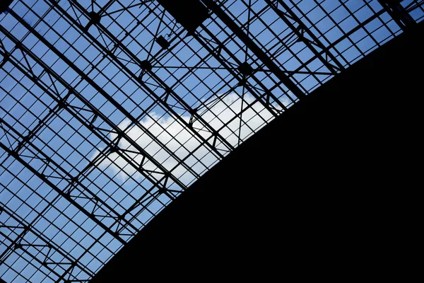 Geometric abstract architecture from the roof of a train station with sky at the background