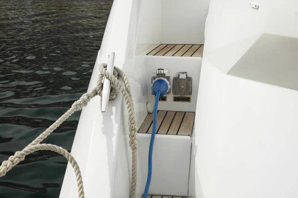 Detail of electric cable plugged in the boat from an auxiliary generator