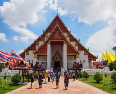 Ziyaretçiler Mongkhon Bophit tapınağının önünde yürümek.