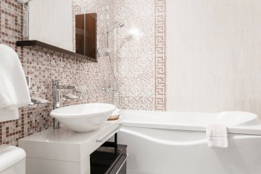 Banyo içinde odalar bir daire veya otel. Temiz beyaz havlu ve bornoz kullanmaya hazır bir askı.