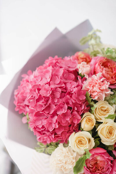 beautiful spring bouquet. flower arrangement with hydrangea and peonies roses. Color light pink. The concept of a flower shop, a small family business