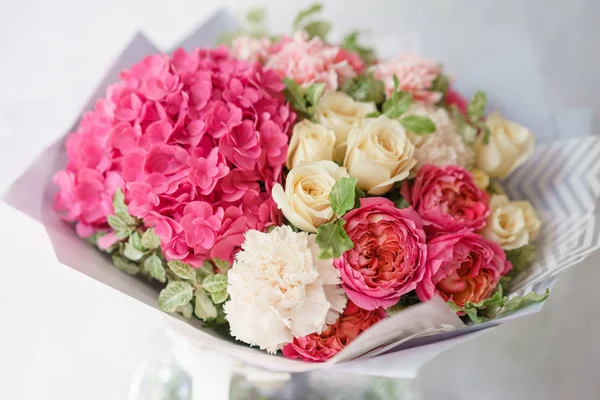 beautiful spring bouquet. flower arrangement with hydrangea and peonies roses. Color light pink. The concept of a flower shop, a small family business