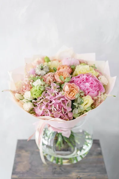 Beautiful summer bouquet. Arrangement with mix flowers. The concept of a flower shop. Work florist.