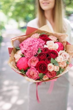 Güzel yaz buket. Mix çiçek aranjmanı. Ortanca çiçek aranjmanı tutan genç kız. Bir çiçekçi dükkanı kavramı. Katalog için içerik