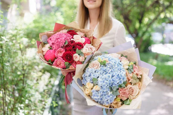 Two Beautiful summer bouquet. Arrangement with mix flowers. Young girl holding a flower arrangement with hydrangea. The concept of a flower shop. Content for the catalog — Stock Photo, Image